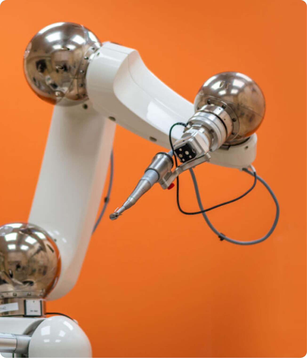 Yomi dental robot, with drill, on an orange background